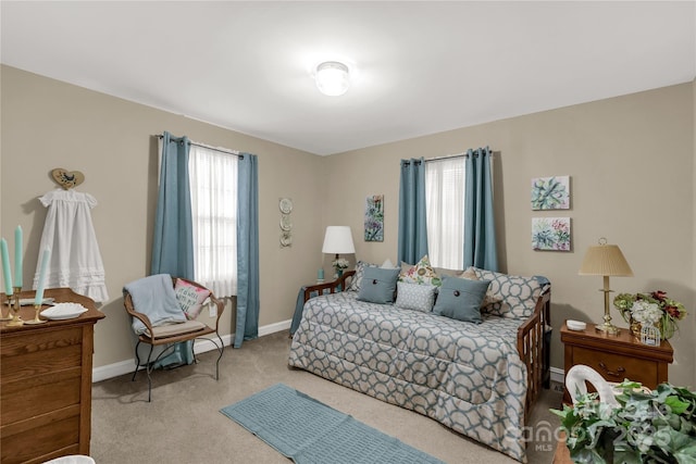 bedroom with light carpet and baseboards