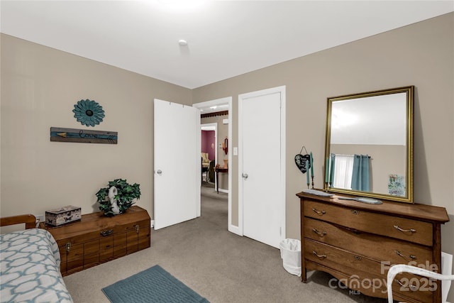 bedroom featuring light carpet