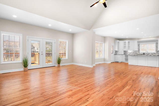 126 Emerald Dr, Mooresville, NC 28117 - unfurnished living room with french doors, baseboards, light wood finished floors, and a ceiling fan