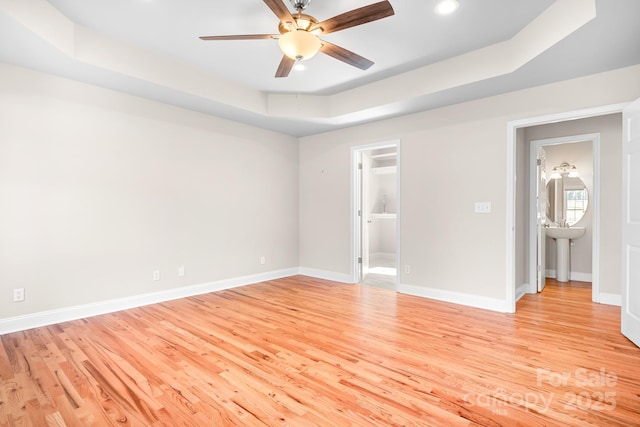 126 Emerald Dr, Mooresville, NC 28117 - interior space featuring light wood-type flooring, ceiling fan, a raised ceiling, baseboards, and recessed lighting