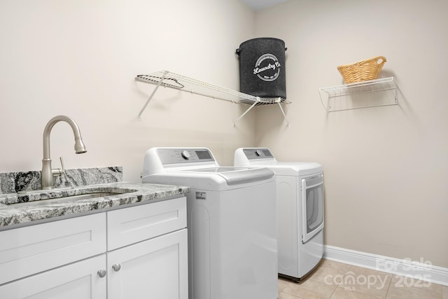 126 Emerald Dr, Mooresville, NC 28117 - laundry area with light tile patterned floors, baseboards, separate washer and dryer, a sink, and cabinet space