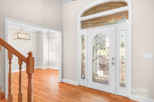 126 Emerald Dr, Mooresville, NC 28117 - foyer entrance featuring a high ceiling, wood finished floors, a notable chandelier, and a healthy amount of sunlight
