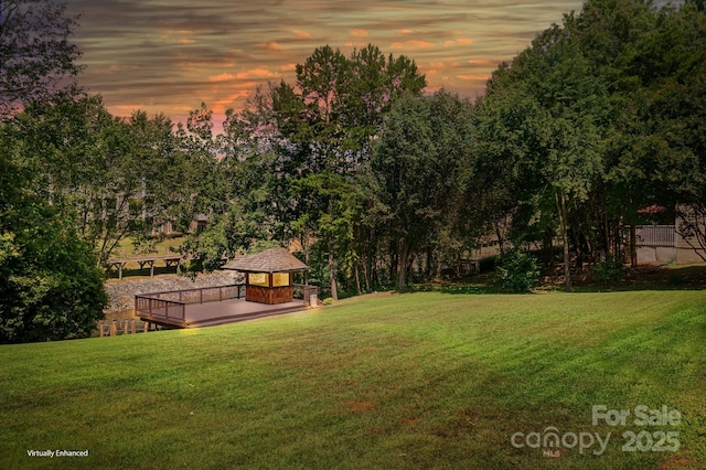 yard at dusk with a gazebo