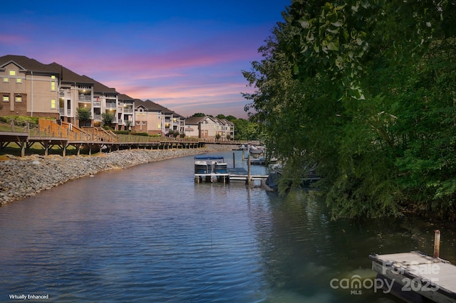 dock area with a water view and a residential view