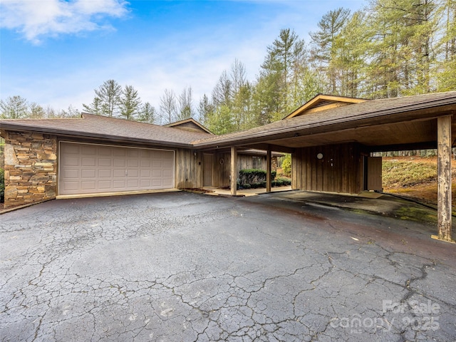 view of front of property featuring a carport and a garage