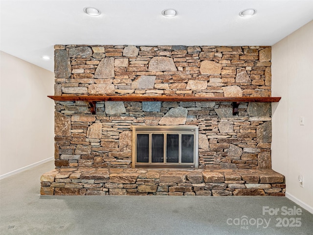 details featuring carpet floors and a stone fireplace