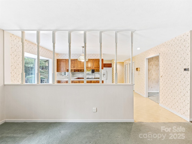 kitchen featuring white fridge with ice dispenser and light colored carpet