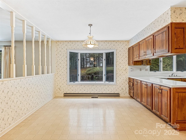 kitchen with baseboard heating and pendant lighting