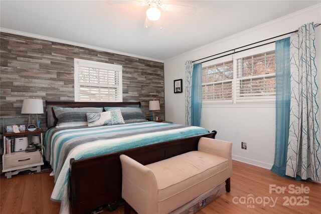 bedroom featuring ceiling fan, ornamental molding, wood finished floors, and baseboards