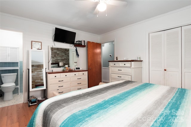 bedroom featuring a closet, ornamental molding, connected bathroom, ceiling fan, and wood finished floors