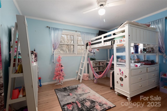 bedroom featuring light wood-style flooring, ornamental molding, ceiling fan, and baseboards