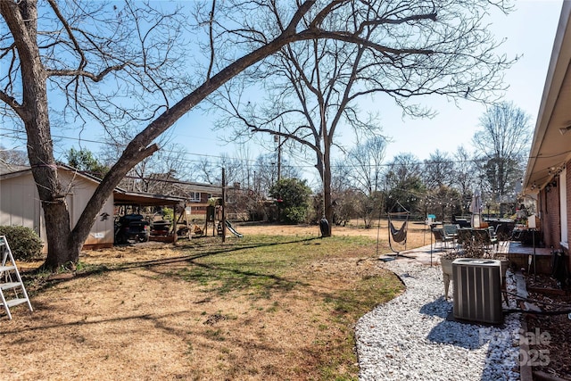 view of yard with a patio area, central AC, and a playground