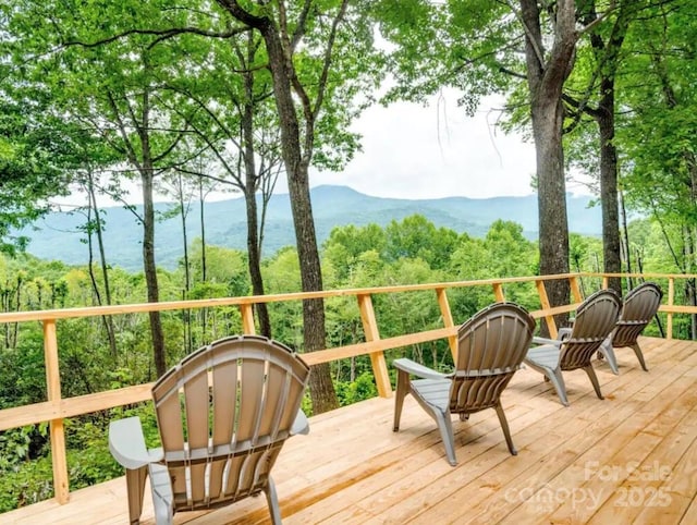 wooden deck featuring a mountain view