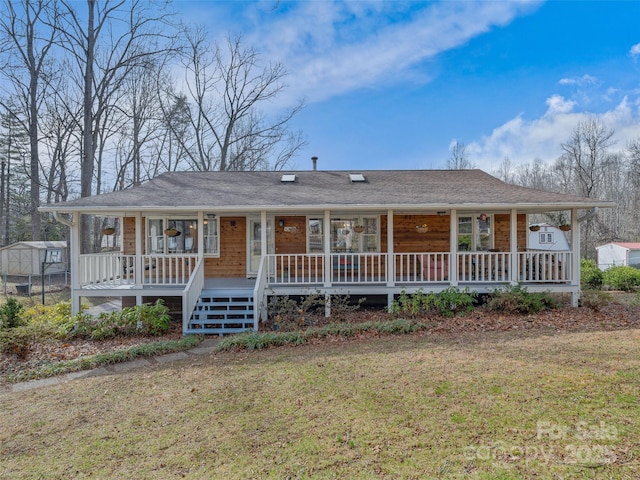 view of front of house with a porch and a front lawn