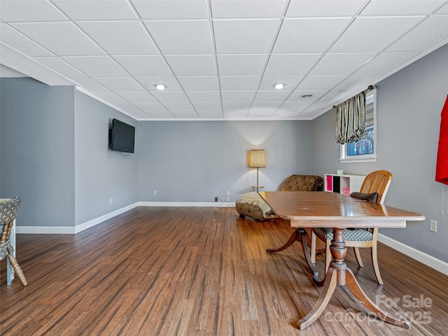 sitting room with a paneled ceiling, baseboards, and wood finished floors