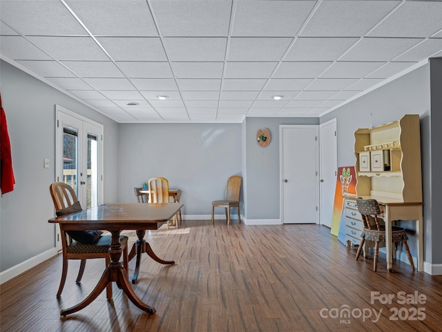 dining room featuring french doors, wood finished floors, a paneled ceiling, and baseboards