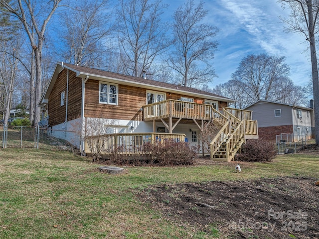 back of house featuring stairway, fence, a deck, and a lawn