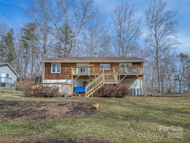 rear view of property with stairs, a deck, and a yard