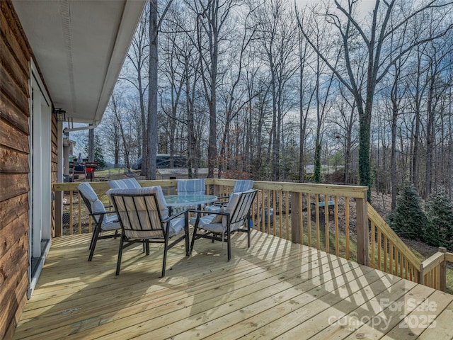 wooden terrace featuring outdoor dining space