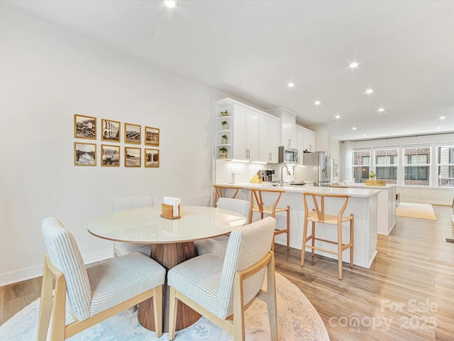 4010 Citra Ln, Charlotte, NC 28217 - dining space featuring light wood-type flooring, baseboards, and recessed lighting