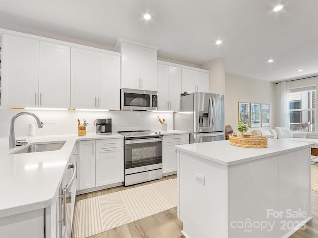 4010 Citra Ln, Charlotte, NC 28217 - kitchen with appliances with stainless steel finishes, a sink, a center island, decorative backsplash, and recessed lighting