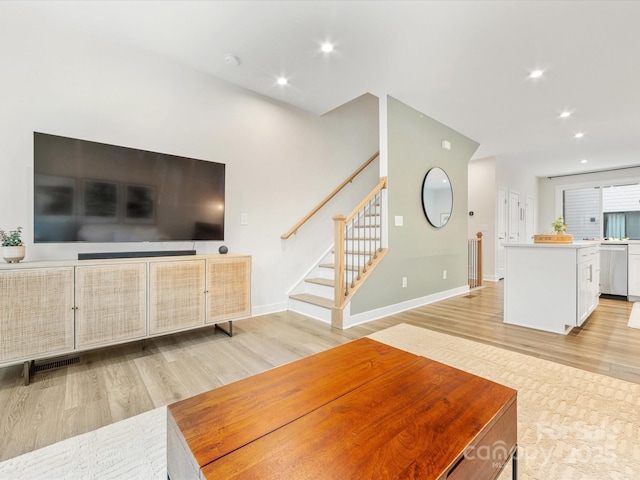 4010 Citra Ln, Charlotte, NC 28217 - unfurnished living room featuring light wood-style floors, recessed lighting, stairway, and baseboards