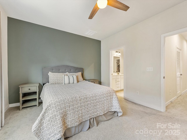4010 Citra Ln, Charlotte, NC 28217 - bedroom featuring light carpet, baseboards, connected bathroom, and a ceiling fan