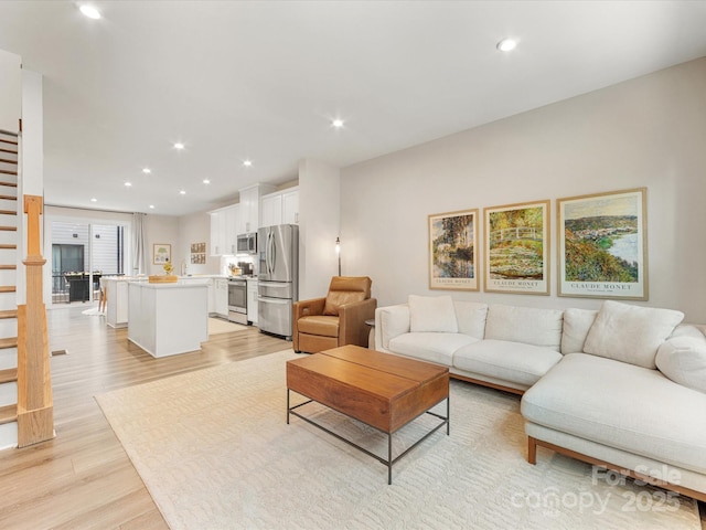 4010 Citra Ln, Charlotte, NC 28217 - living area featuring light wood finished floors, recessed lighting, and stairway