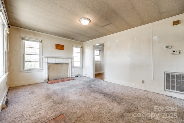 unfurnished living room featuring carpet and a textured ceiling