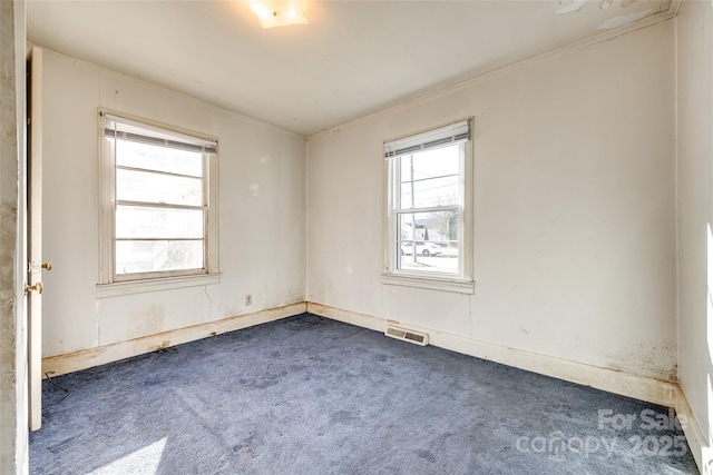 carpeted empty room featuring ornamental molding