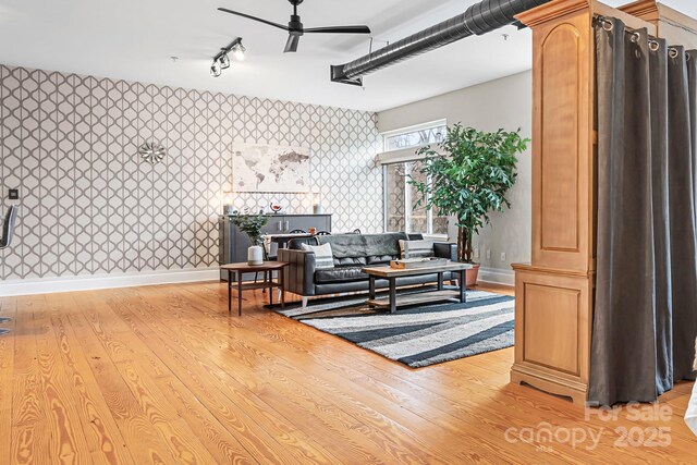 living room with ceiling fan, light wood-type flooring, and track lighting