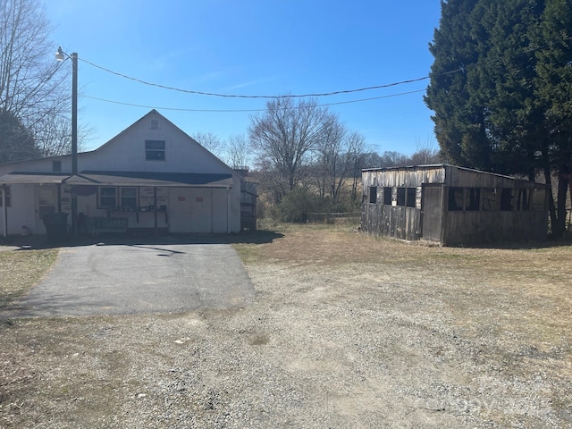 exterior space with aphalt driveway and a porch