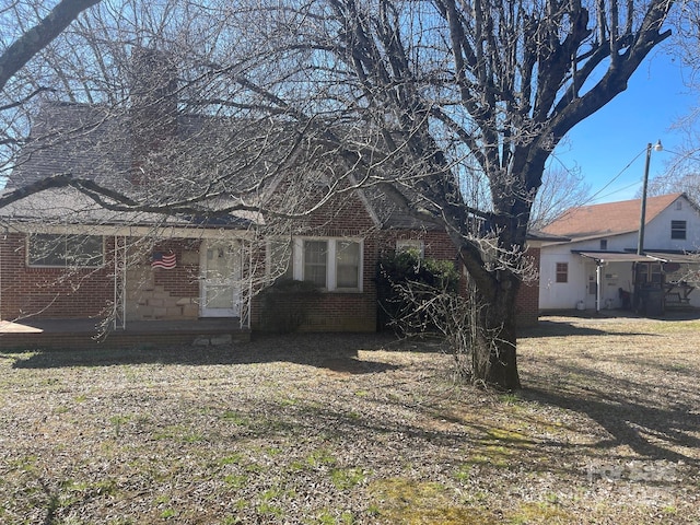 rear view of property with brick siding