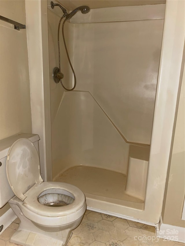 full bath with a stall shower and toilet