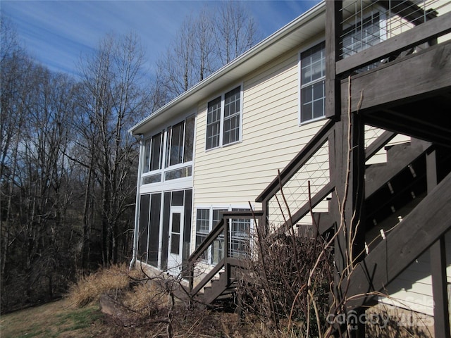 view of home's exterior with a sunroom