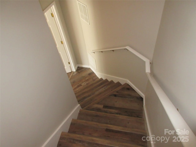 stairs featuring hardwood / wood-style floors