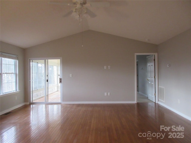 empty room featuring ceiling fan, vaulted ceiling, and hardwood / wood-style floors