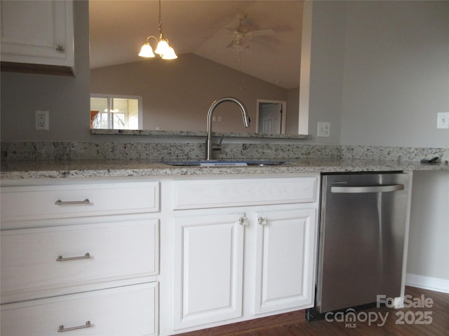 kitchen featuring stainless steel dishwasher, sink, light stone countertops, and white cabinets