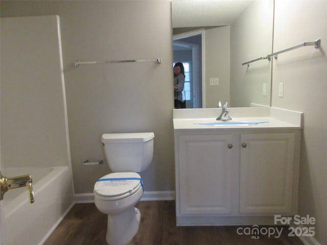 bathroom featuring hardwood / wood-style flooring, vanity, and toilet