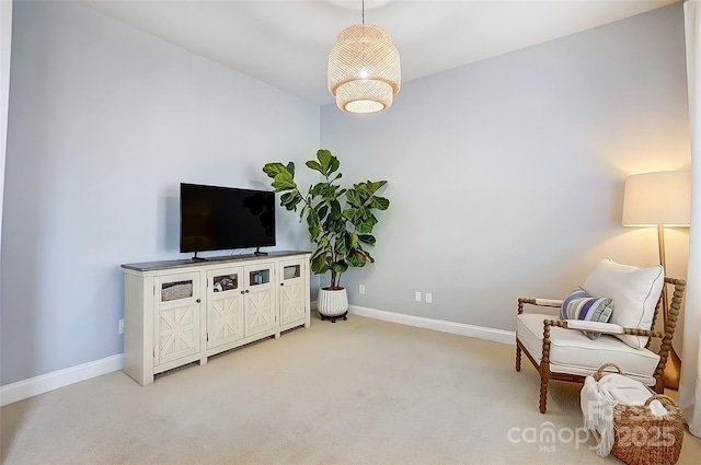 sitting room with light colored carpet and baseboards