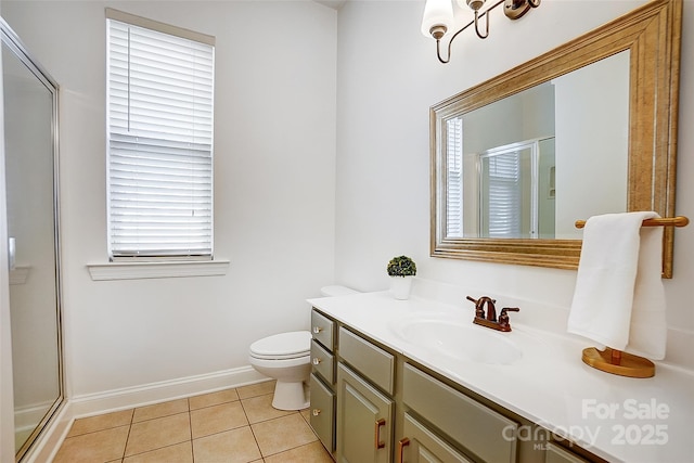 full bath featuring toilet, a stall shower, vanity, tile patterned flooring, and baseboards