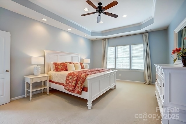 bedroom featuring a tray ceiling, crown molding, recessed lighting, light colored carpet, and baseboards