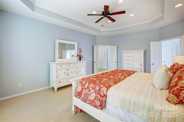 bedroom with a tray ceiling, light colored carpet, baseboards, and recessed lighting