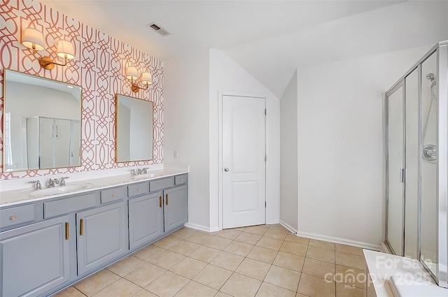 bathroom with double vanity, visible vents, tile patterned floors, a shower stall, and a sink