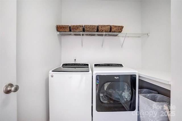 washroom featuring laundry area and washing machine and clothes dryer