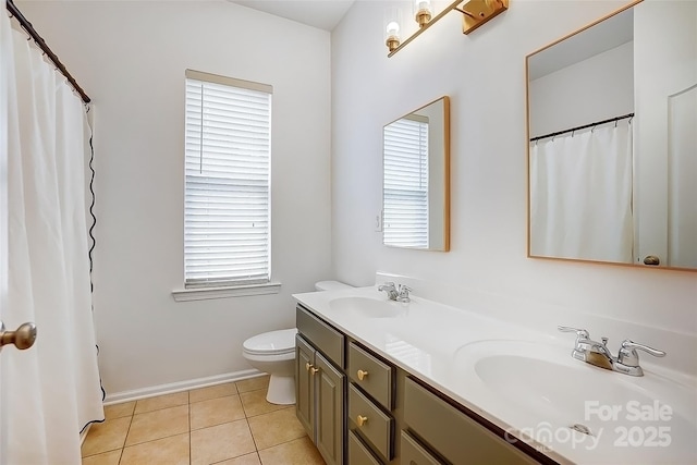 bathroom with a wealth of natural light, tile patterned flooring, and a sink