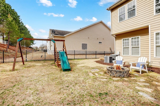 view of yard with an outdoor fire pit, a playground, and fence