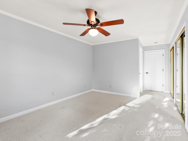 2302 Deermouse Way, Hendersonville, NC 28792 - unfurnished bedroom with crown molding, a closet, a ceiling fan, light carpet, and baseboards