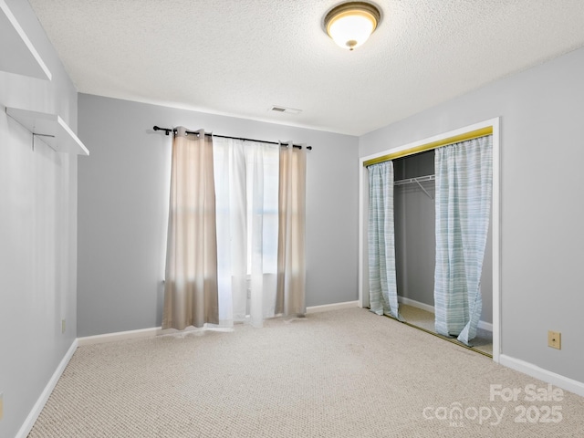 2302 Deermouse Way, Hendersonville, NC 28792 - unfurnished bedroom featuring carpet, a closet, visible vents, and baseboards