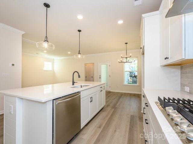 kitchen featuring crown molding, exhaust hood, light wood-style floors, appliances with stainless steel finishes, and a sink